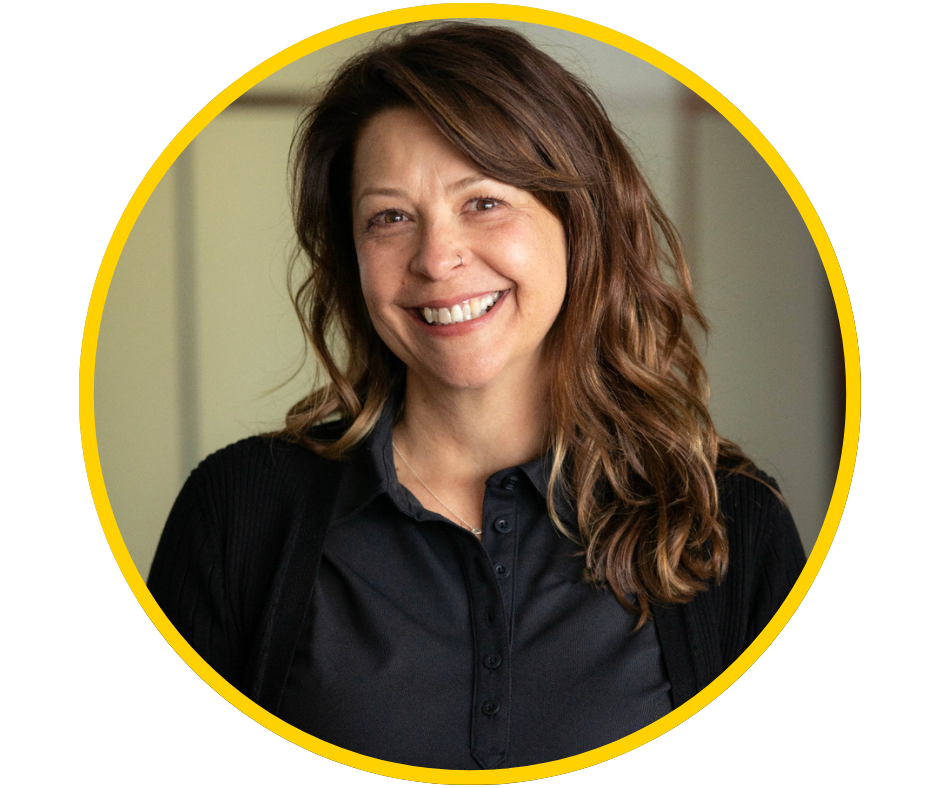 Jennifer, a light skinned woman with long brown hair and a nose ring smiles brightly in a professional headshot.