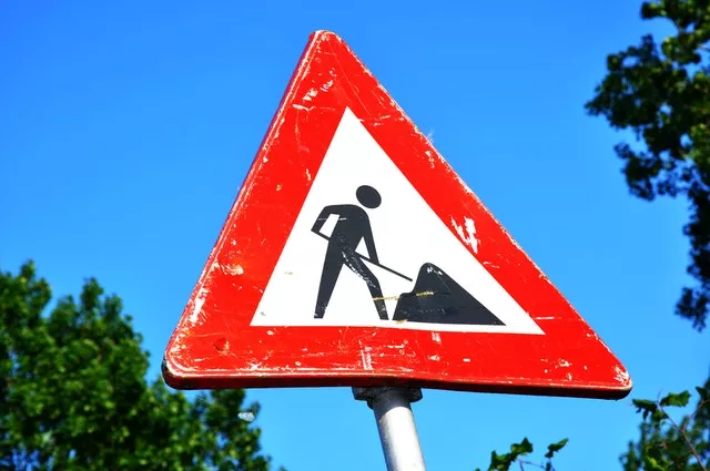 under construction: a sign showing a figure shoveling