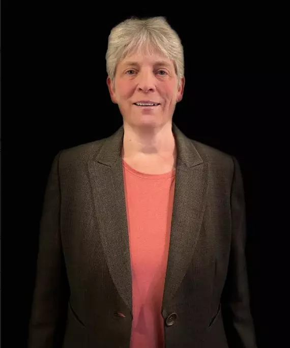 Connie Brachtenbach in a brown blazer and salmon top