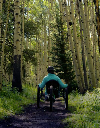 person using a recumbent bicycle on a  mountain trail